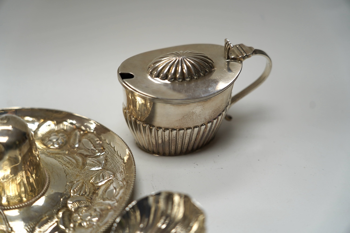 Four assorted 19th century silver wine labels, including a pair 'Sherry & Claret' by Joseph Wilmore, Birmingham, 1810, a Mexican 925 hat, a George III sauce ladle, by Eley & Fearn, London, 1802, a pair of silver sugar ni